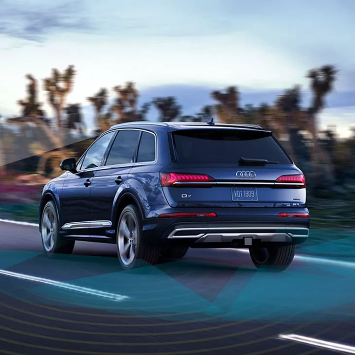 Rear-view of the Audi Q7 driving on the road.