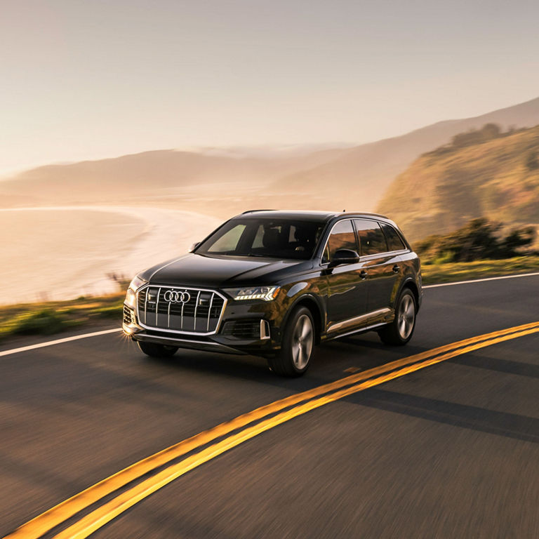 Three-quarter front view of the Audi Q7 accelerating.