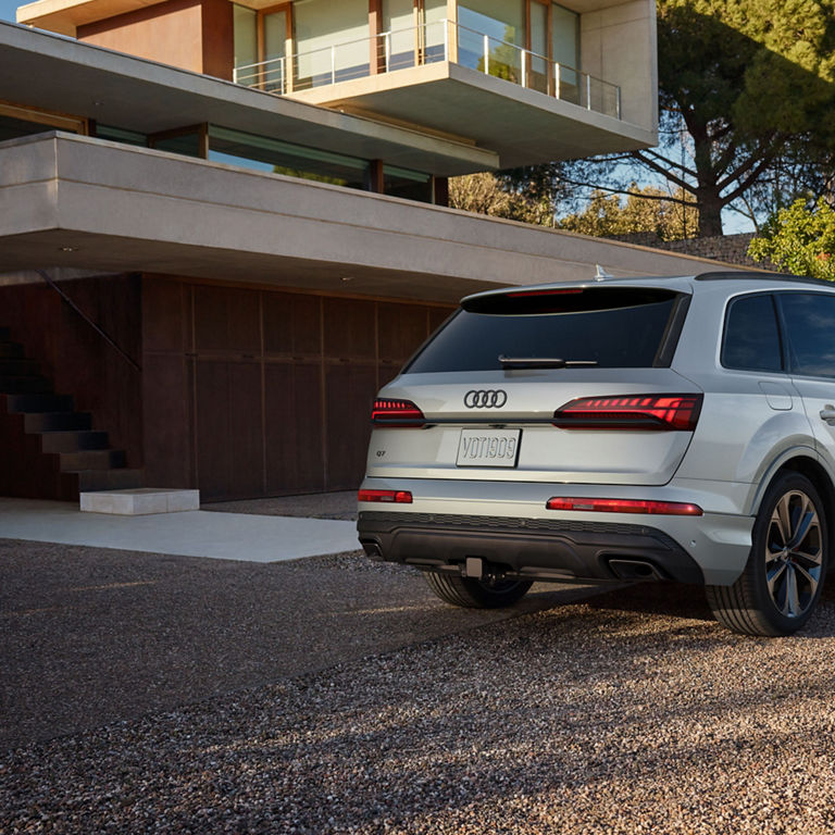 Three-quarter side profile of a black Audi Q7 parked.
