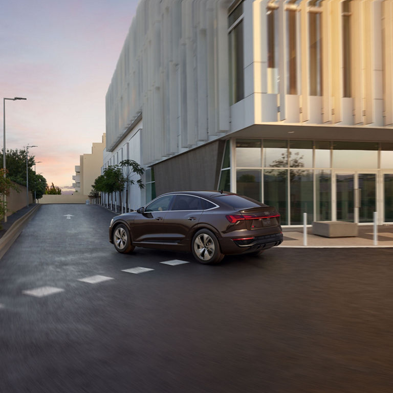 Three-quarter rear view of the Audi Q8 e-tron® Sportback accelerating. 