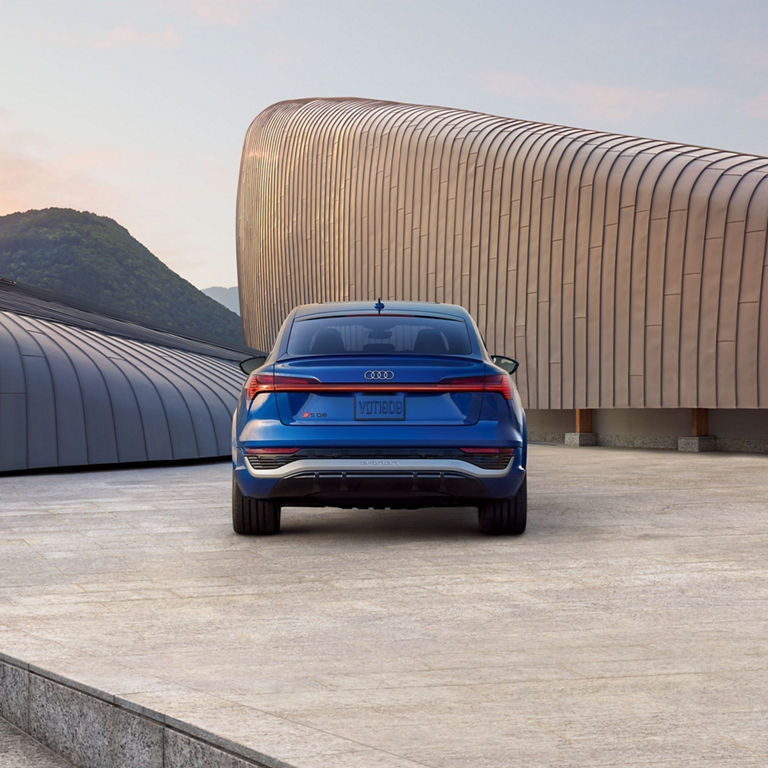 Rear profile of a blue Audi SQ8 Sportback e-tron.