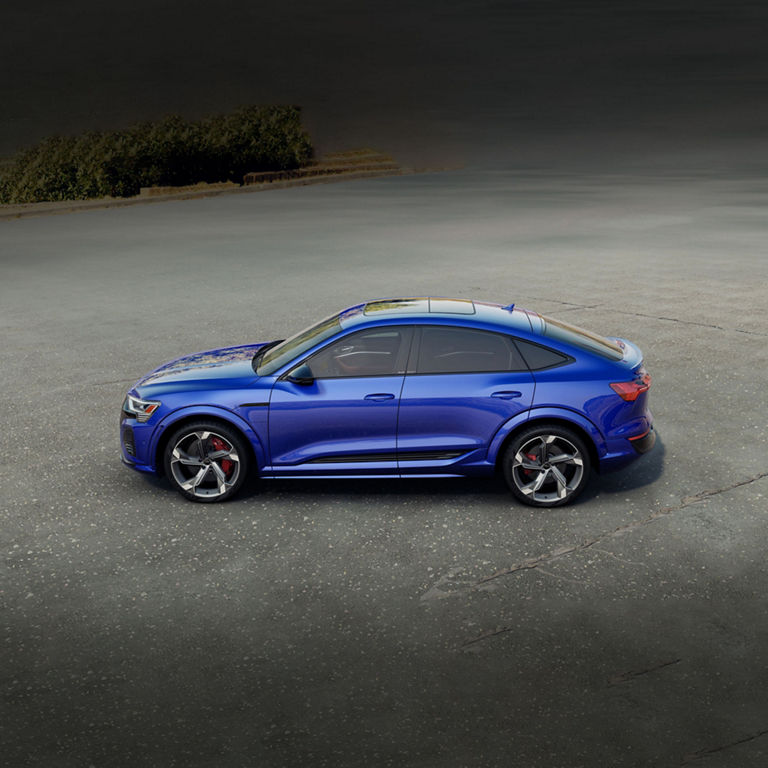 Aerial side view of a blue Audi SQ8 Sportback e-tron parked.