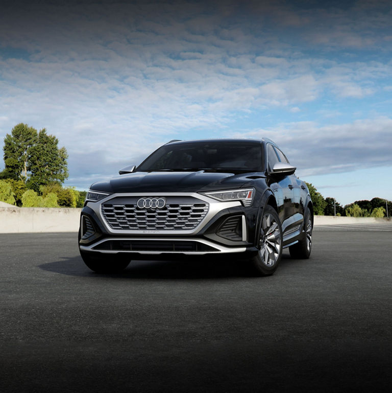 Three-quarter front-view of a black Audi SQ8 e-tron parked.