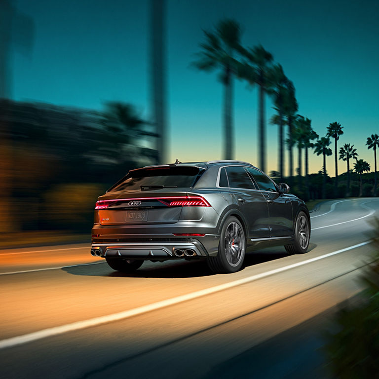 Elevated front profile of the Audi SQ8 accelerating.