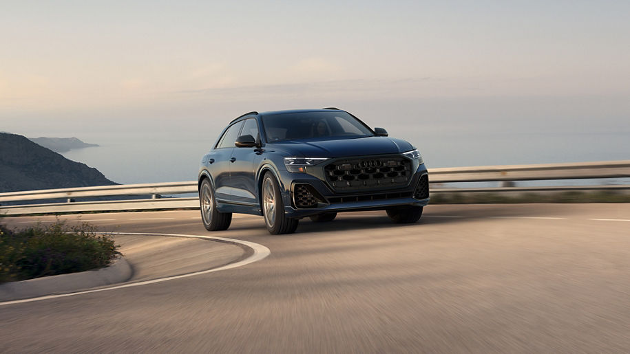Three-quarter front view of the Audi SQ8 accelerating.
