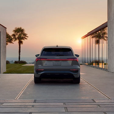 Rear profile of a gray Audi Q8 e-tron parked.