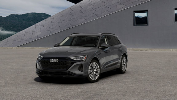 Elevated three-quarter front profile of a gray Audi Q8 e-tron®.