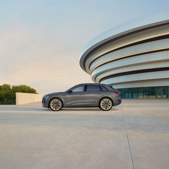Side profile of a gray Audi Q8 e-tron parked.