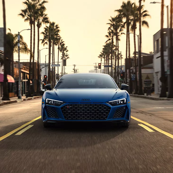 Front profile Audi R8 Coupe driving on the road.