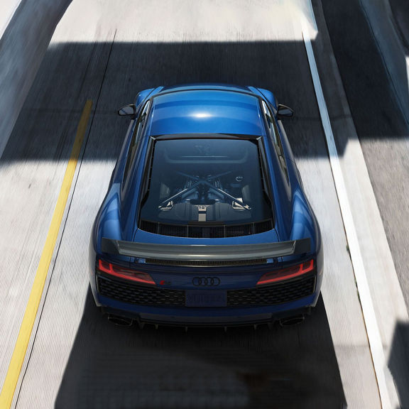 Aerial rear-view of the Audi R8 Coupe on the road.