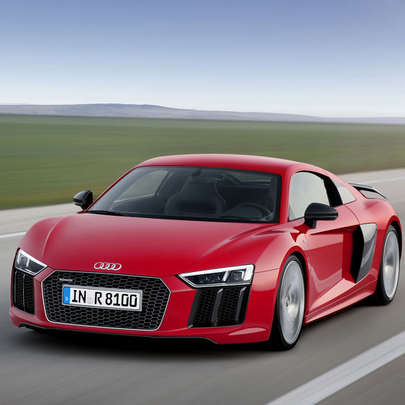 Three-quarter front view of a red 2nd-generation Audi R8 in motion.