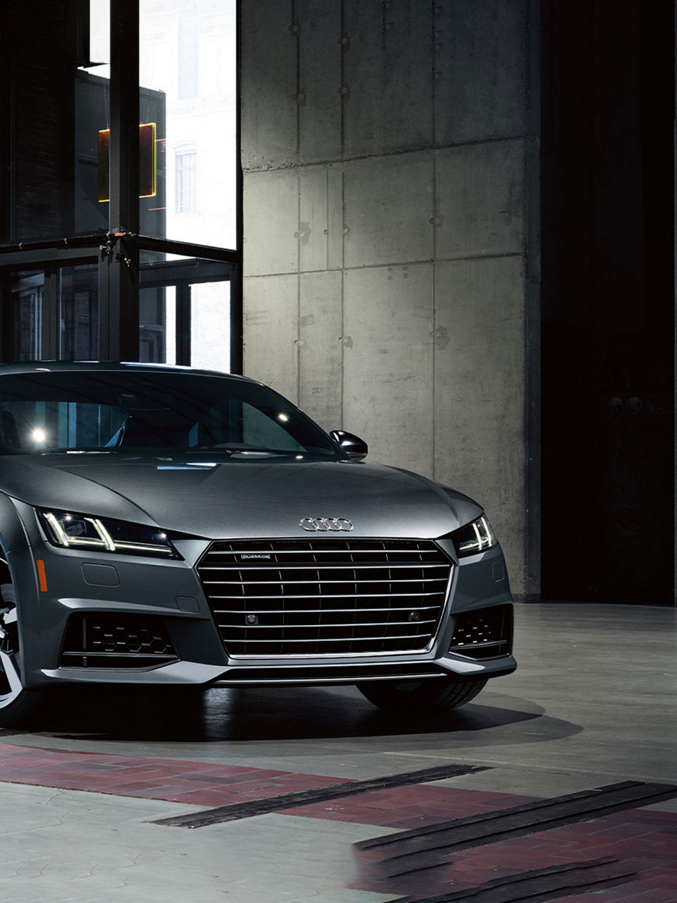 Three-quarter front view of the Audi TT Coupe.