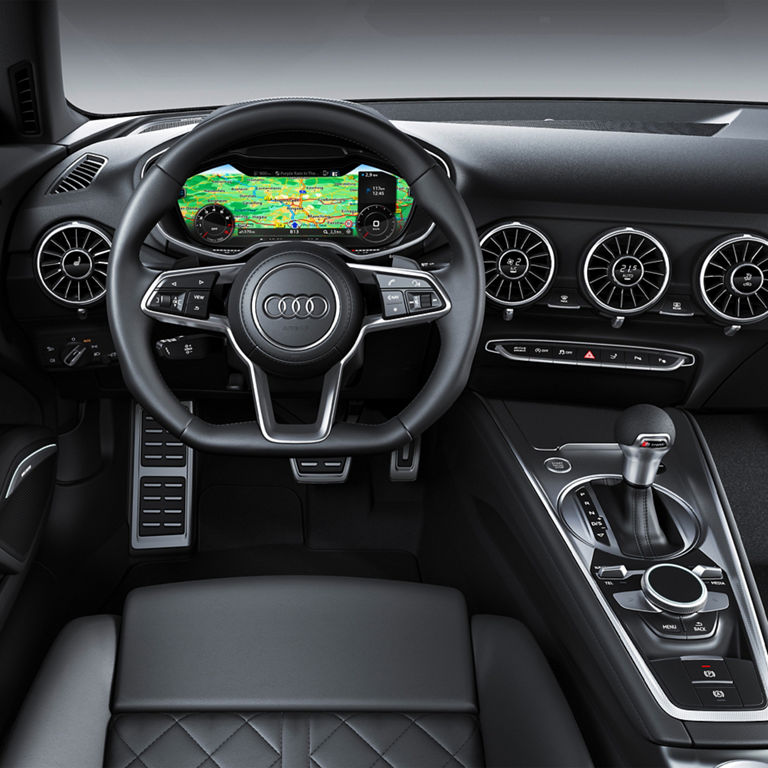 Interior shot of the drivers cockpit of an Audi TT vehicle. 