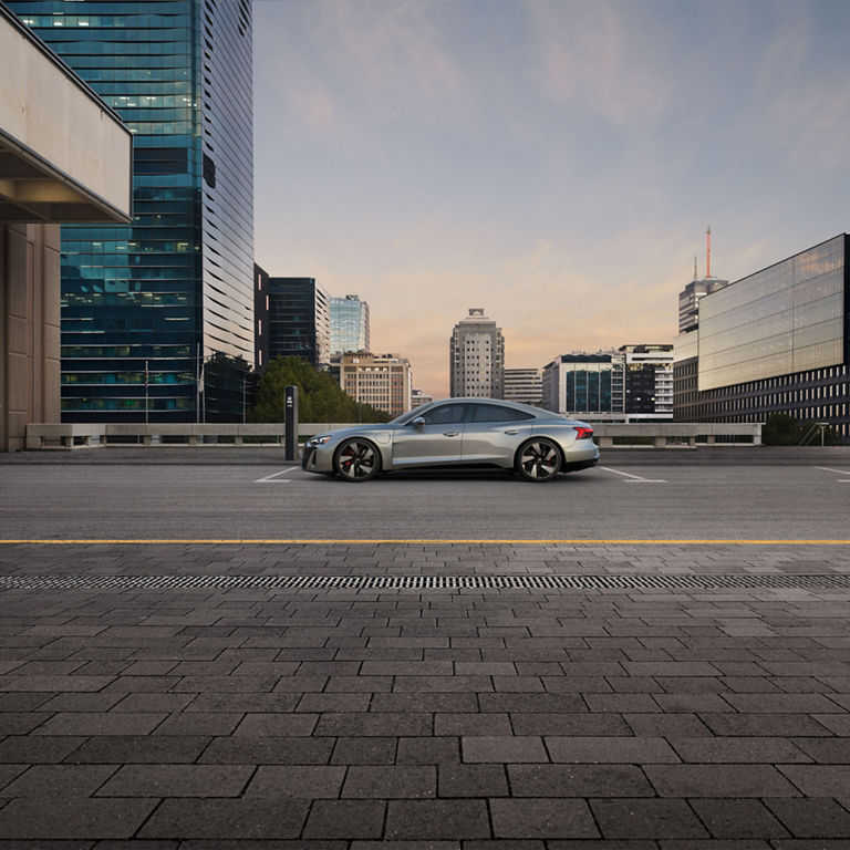 Side profile of the Audi S e-tron GT parked and charging.