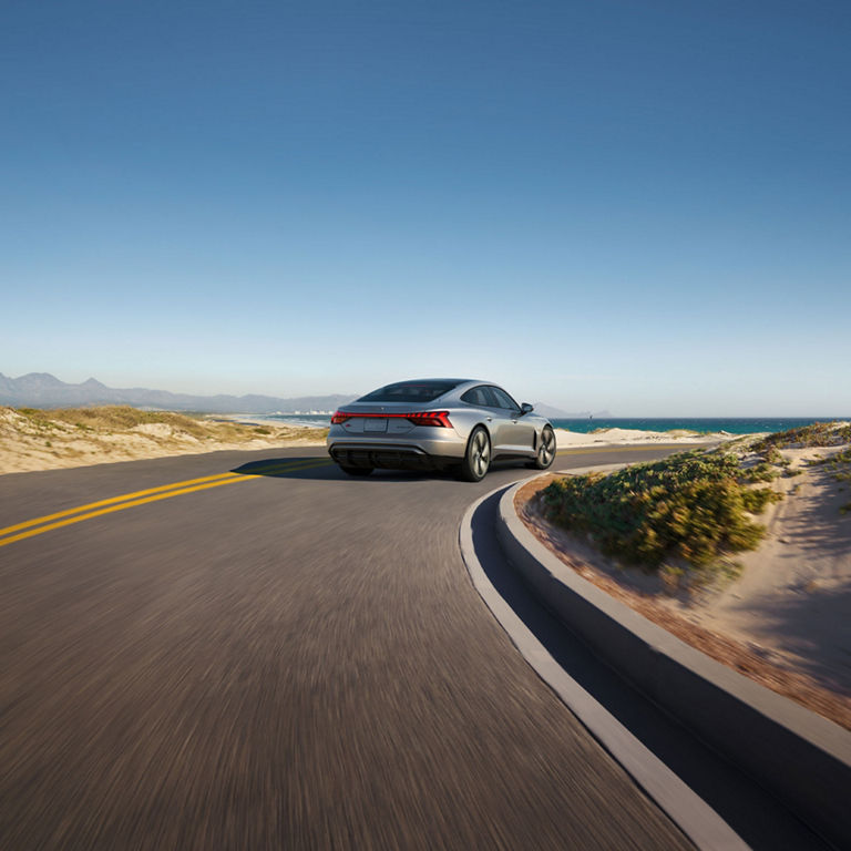 Three-quarter rear view of the Audi S e-tron GT in motion.