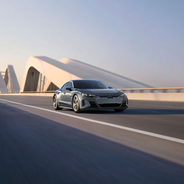 Three quarter view of an e-tron GT in motion.