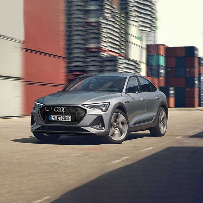 Three-quarter front view of the Audi e-tron® Sportback accelerating.