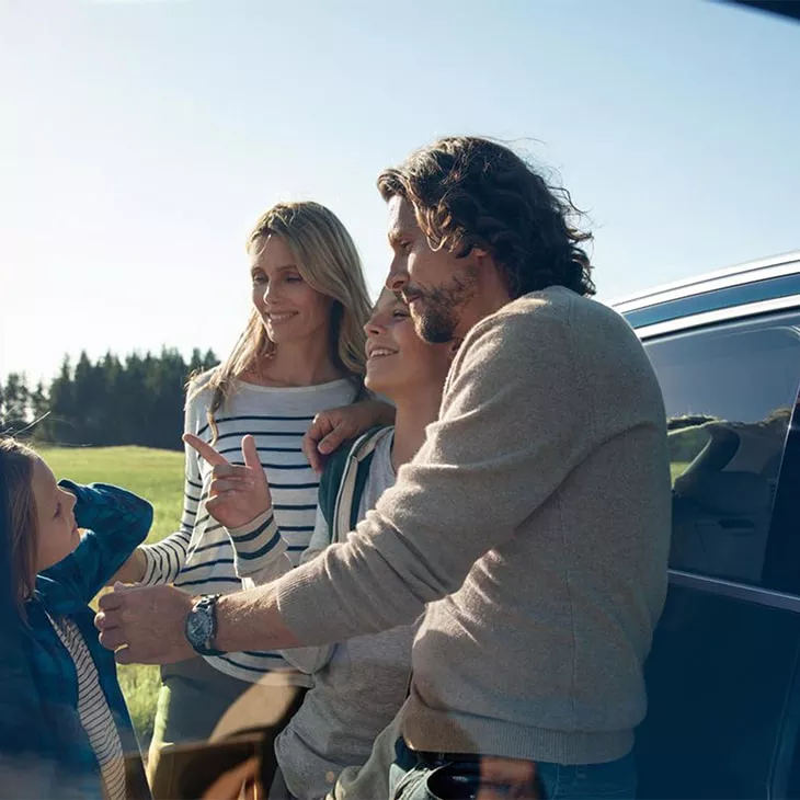 Family standing beside Audi e-tron®.