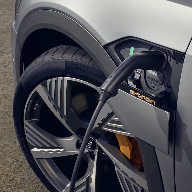Close-up of the wheel and charging port in Audi e-tron® Sportback.