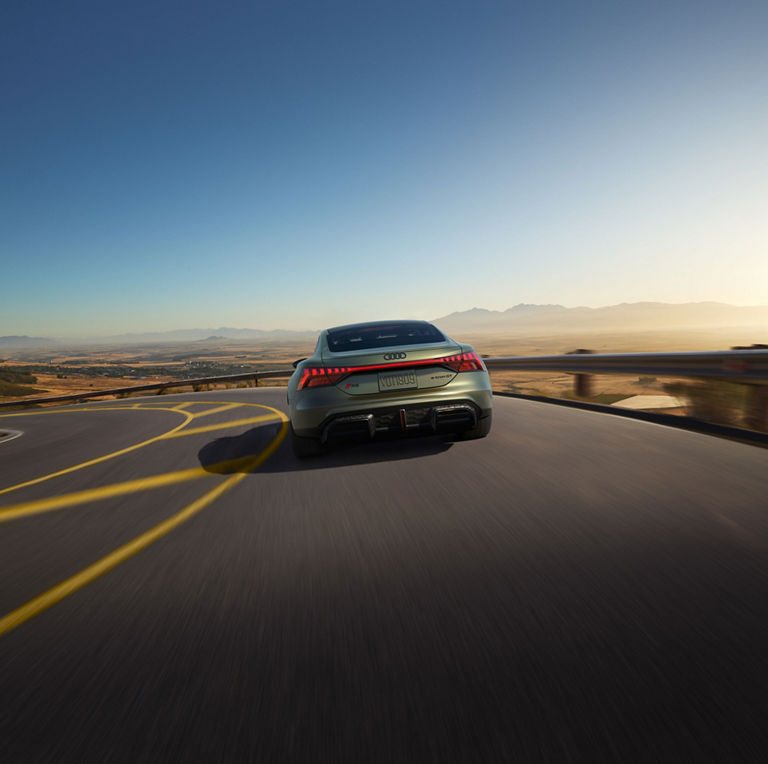 Rear view of the Audi RS e-tron GT in motion.