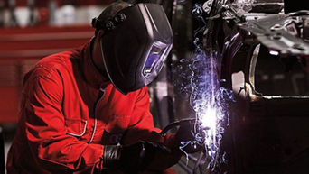 An Audi mechanic working on a car. 