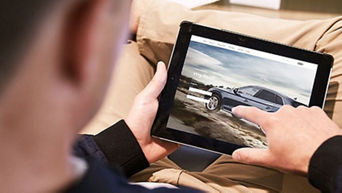 A man using the myAudi app on his tablet. 