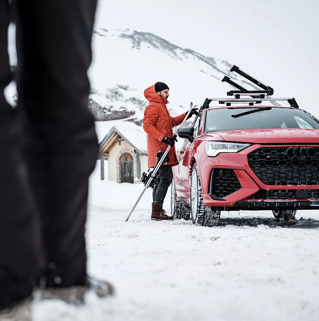 Close-up of the Audi Original Winter Tires that are designed to remain pliable below 45°F with person in the background taking a picture. 