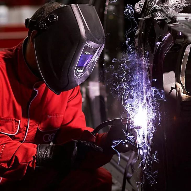 An Audi technician welding a vehicle.  