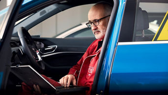 An Audi technician performing a diagnostic test on an Audi. 