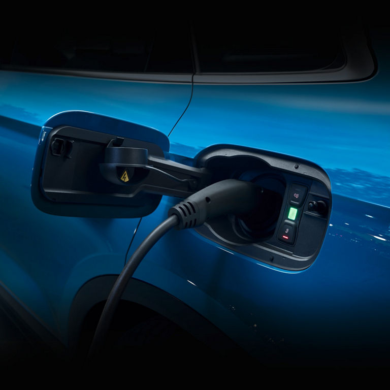 Close-up of the charging port of a blue Audi EV.