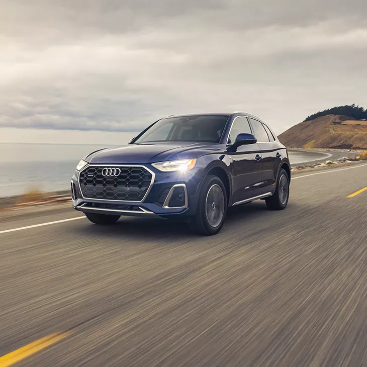 Three quarter front view of the Audi Q5 accelerating. 