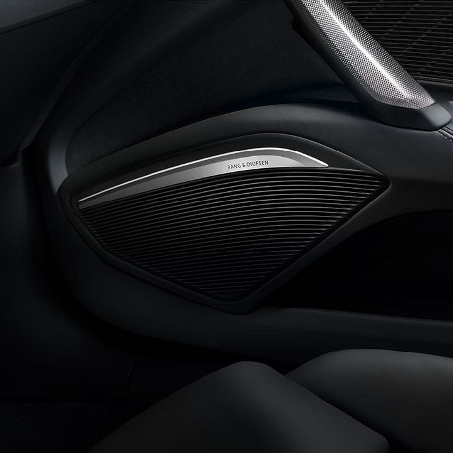 A close-up photo of a Bang & Olufsen speaker inside an Audi vehicle.