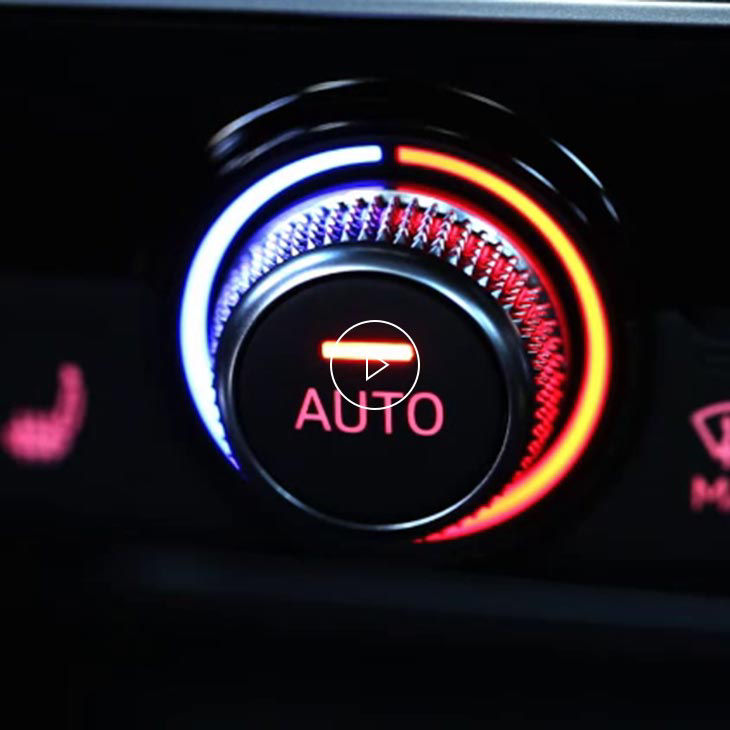 A close-up photo of the automatic climate control button inside an Audi vehicle.