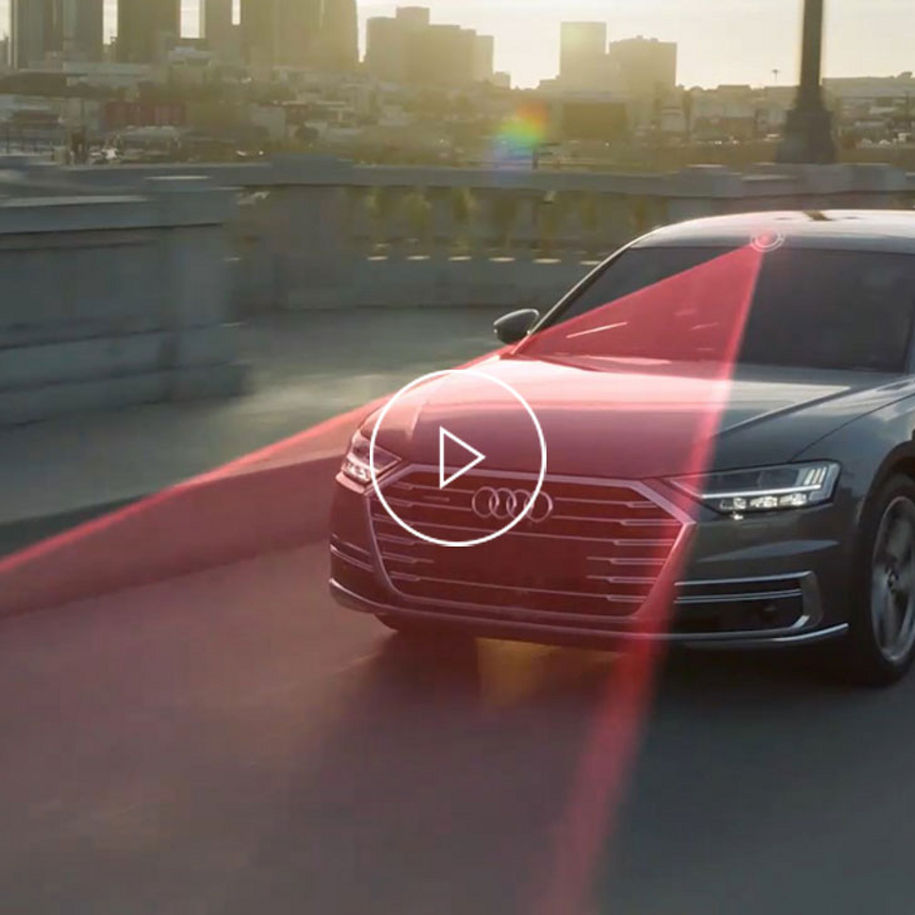 Close-up photo of an Audi vehicle with a dramatization of Lane guidance sensors. 