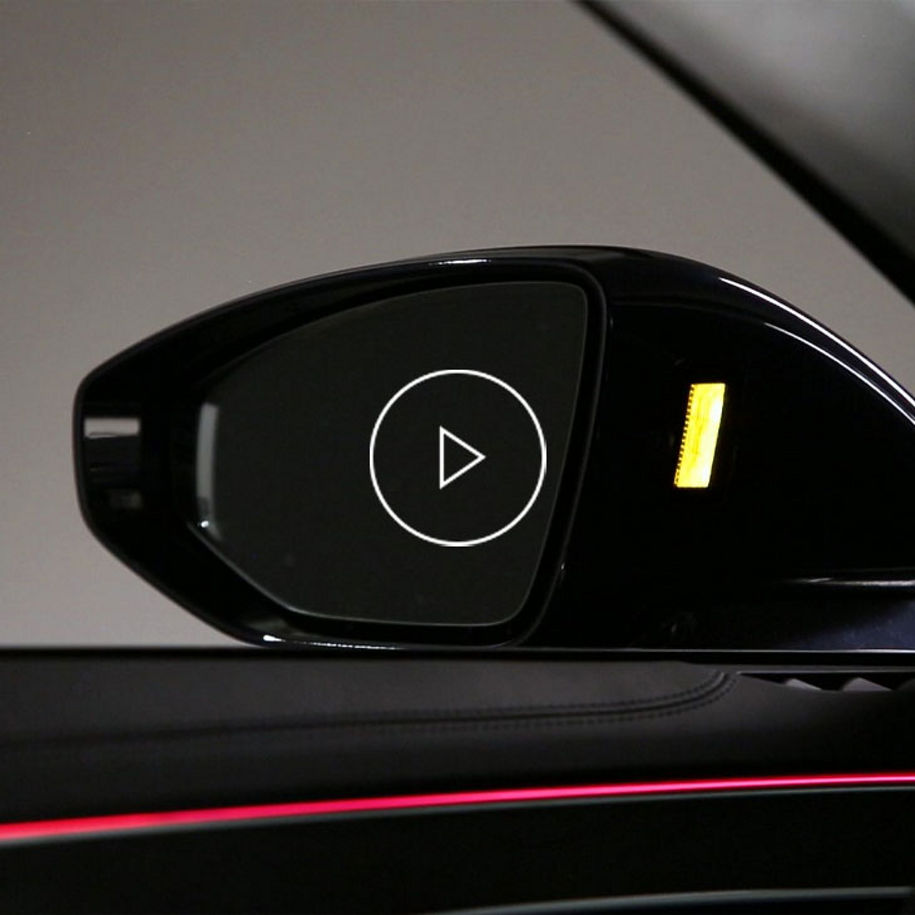 Close-up photo of the side mirror displaying side assist feature in an Audi.