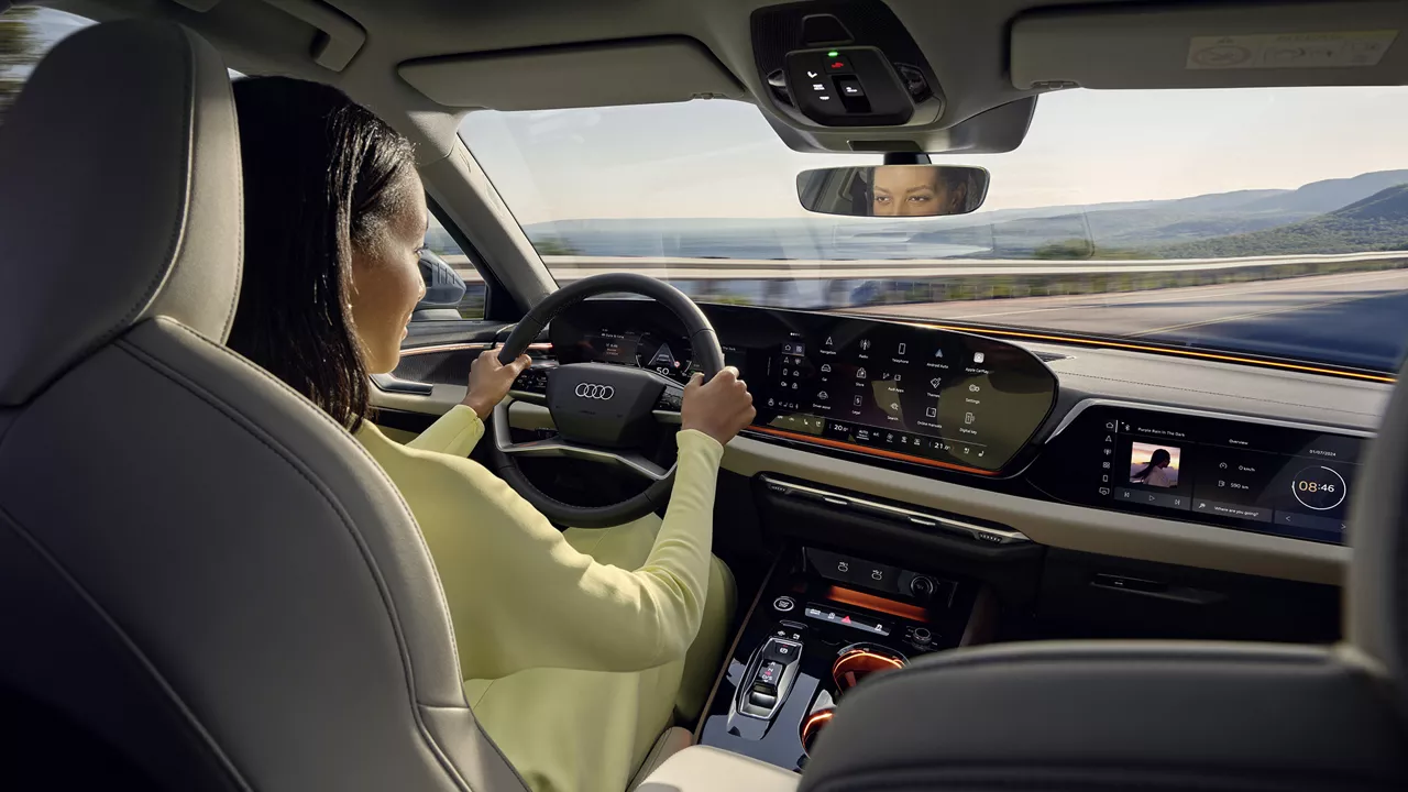 Person in a driver's seat of an Audi Vehicle