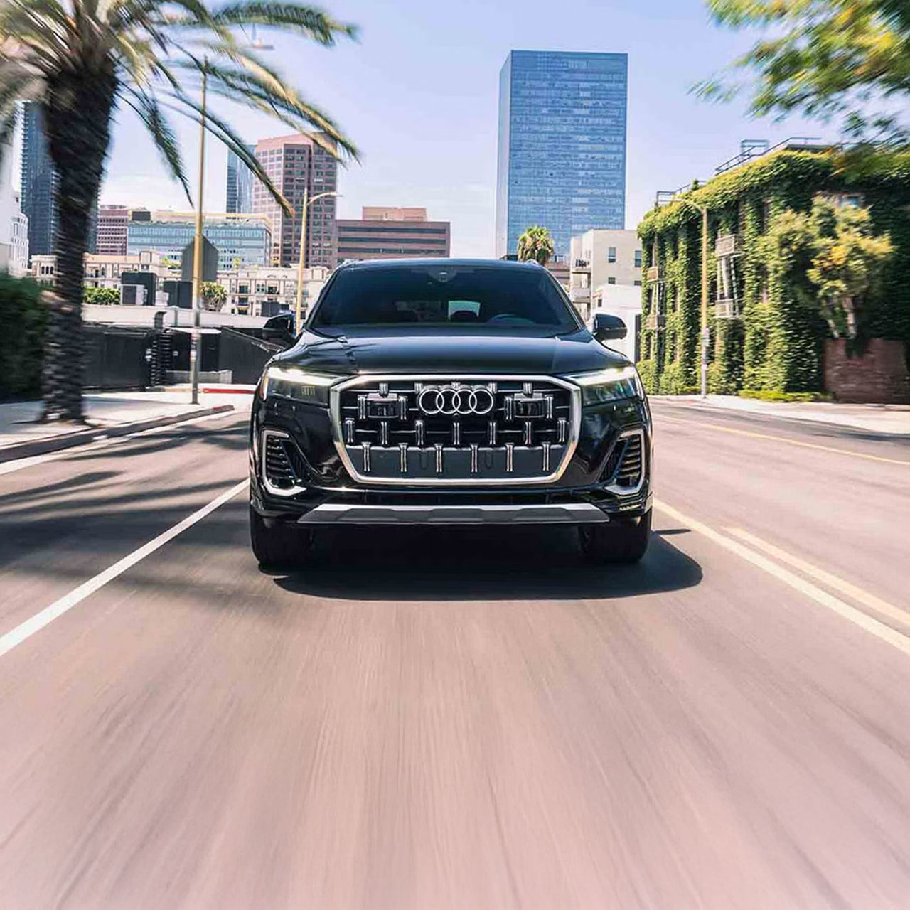 Front profile view of an Audi Q7 accelerating.