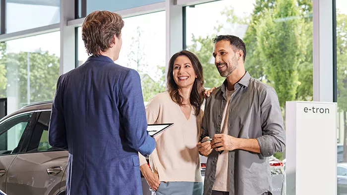 An Audi service advisor and customers