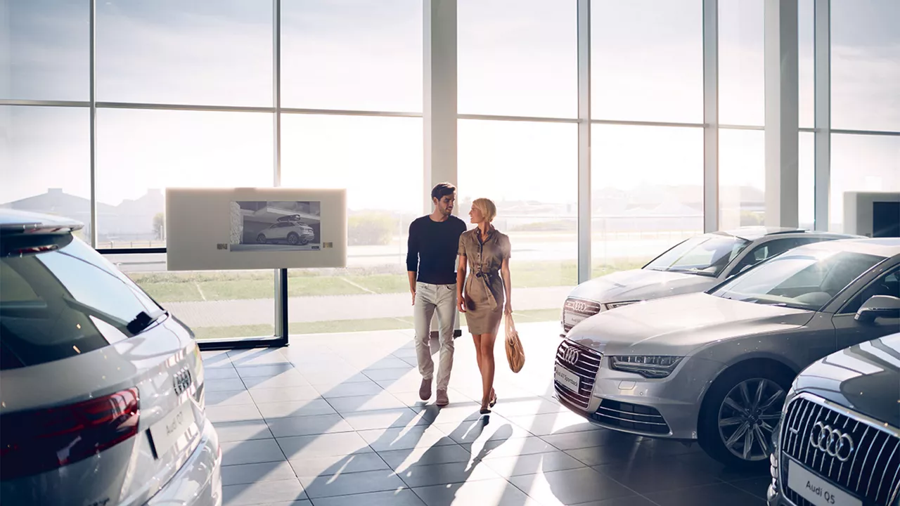 Man and woman walking into Audi Service Centre.