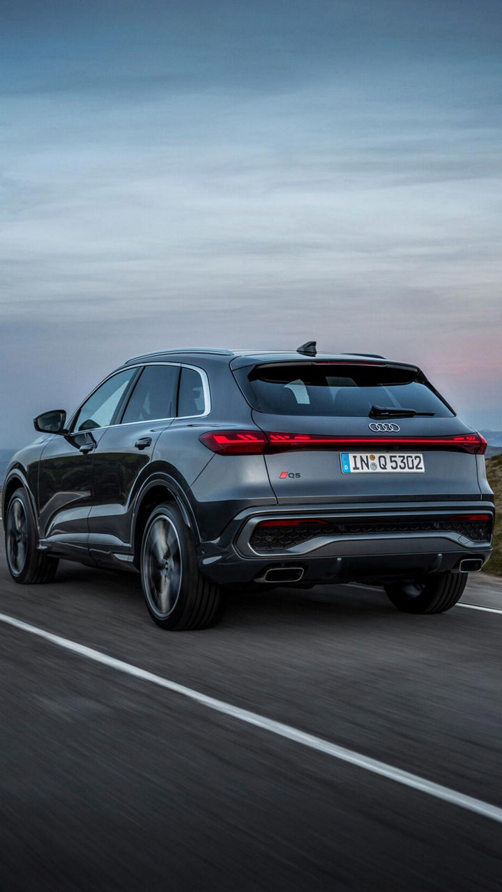 Three-quarter back view of the 2025 Audi Q5 on the road.