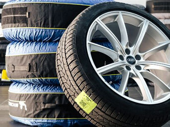 Service technician servicing tire.