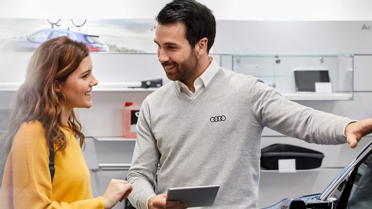 Audi service technician servicing a vehicle.