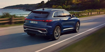 Back view of Audi vehicle accelerating. 