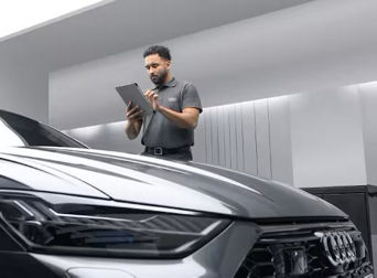 Service technician servicing vehicle.