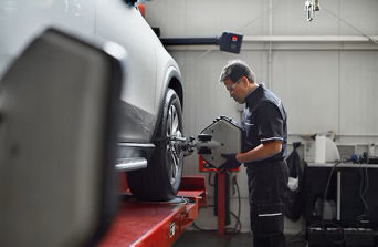 Service technician serving vehicle.