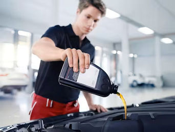 Service technician serving vehicle.