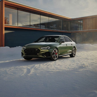 Audi A4 equipped with winter tires parked on a snow-covered road