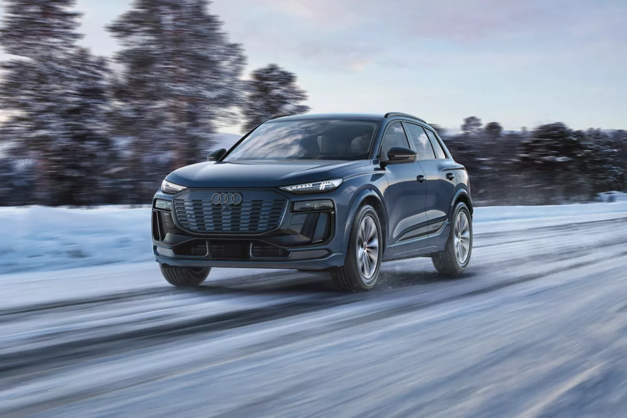 Audi Q6 e-tron driving confidently through snowy roads, demonstrating superior grip and control with Audi winter tires installed