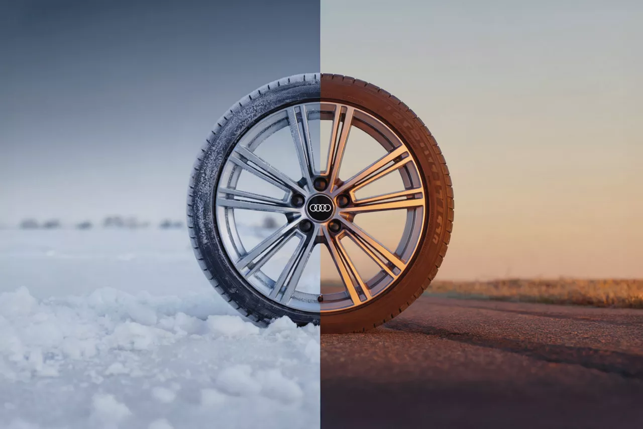 Close-up comparison of winter tires versus all-season tires on an Audi vehicle