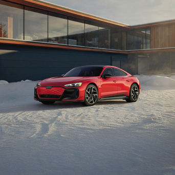 Audi e-tron GT equipped with winter tires parked on a snow-covered road
